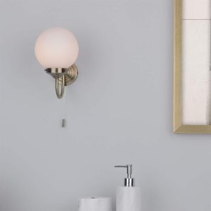 Barclay IP44 Switched Bathroom Wall Light In Antique Brass with Opal Shade
